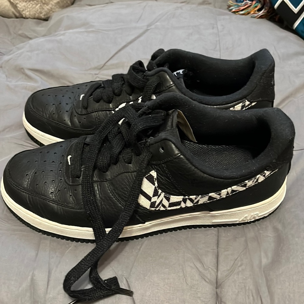 Black Nike with black and white stripes